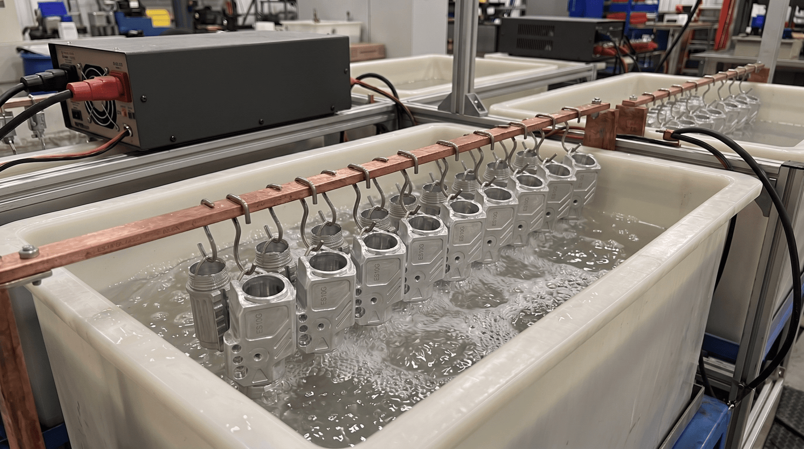 Anodizing process - aluminum parts submerged in electrolytic bath